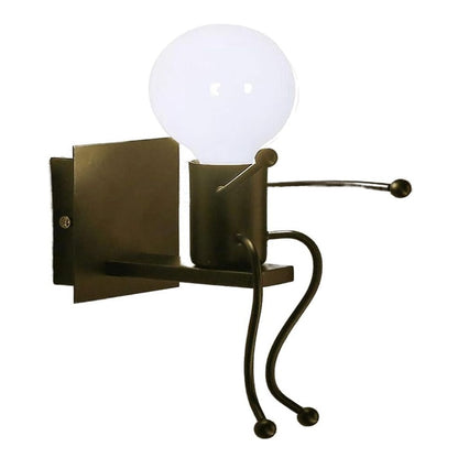 Universo - Applique da Parete Decorativo a Forma di Omino - Lampada da Muro in Metallo con Attacco E27 per Arredo Casa Soggiorno Ingresso (Omino Seduto Nero)